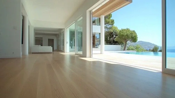 Modern coastal home with light timber flooring and open poolside design